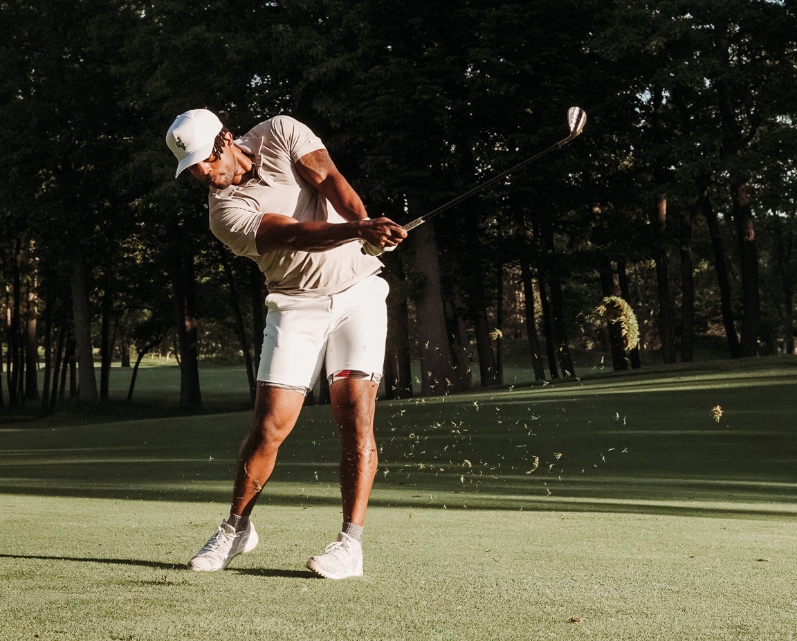 100 Hole Hiker swinging his club on the golf course