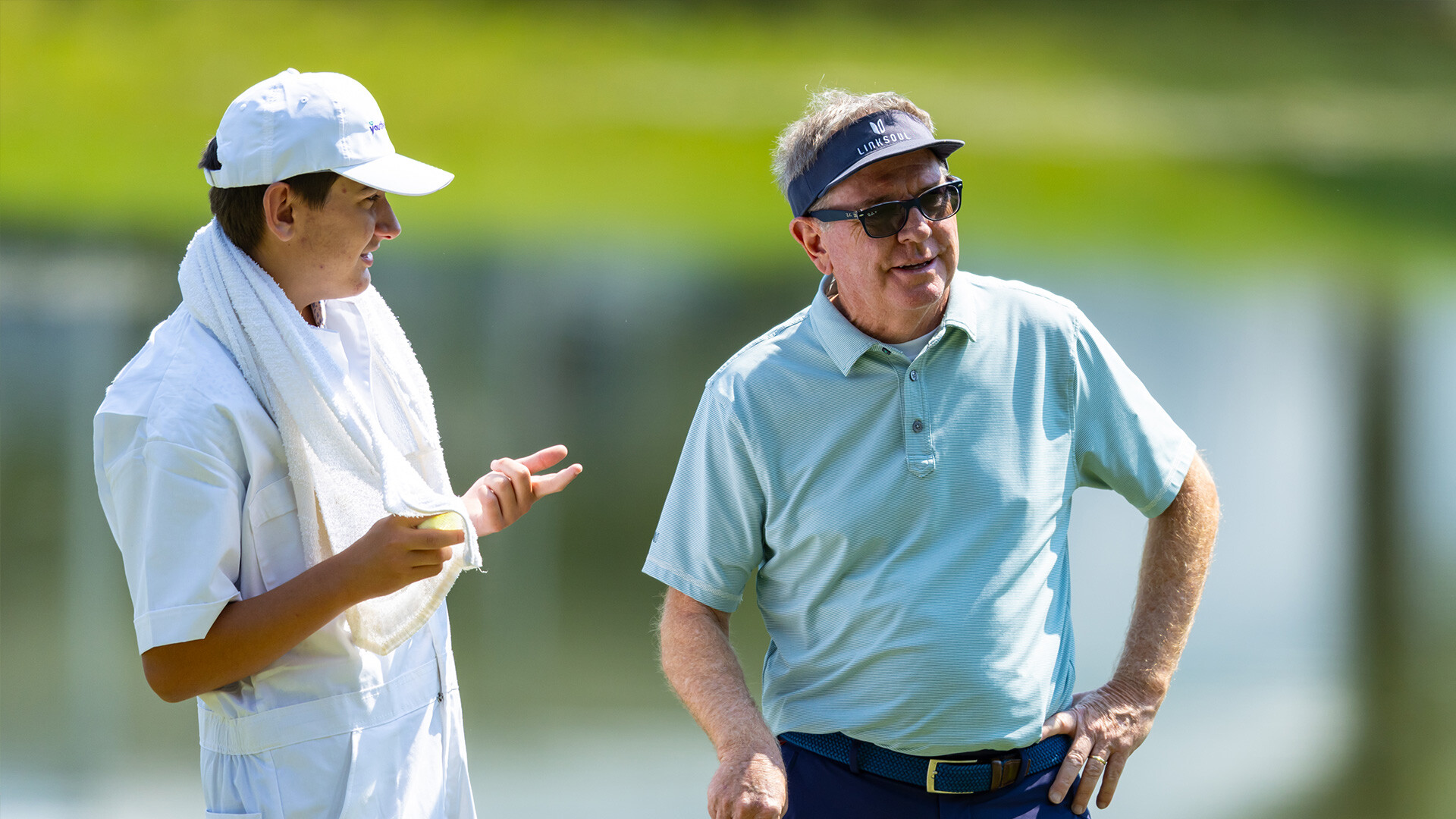 Youth on Course member caddying for amateurs alongside pros