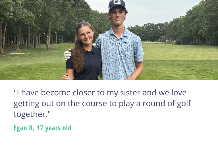Two youth golfers, a brother and sister, smile on a golf course with clubs in hand and their arms around each other