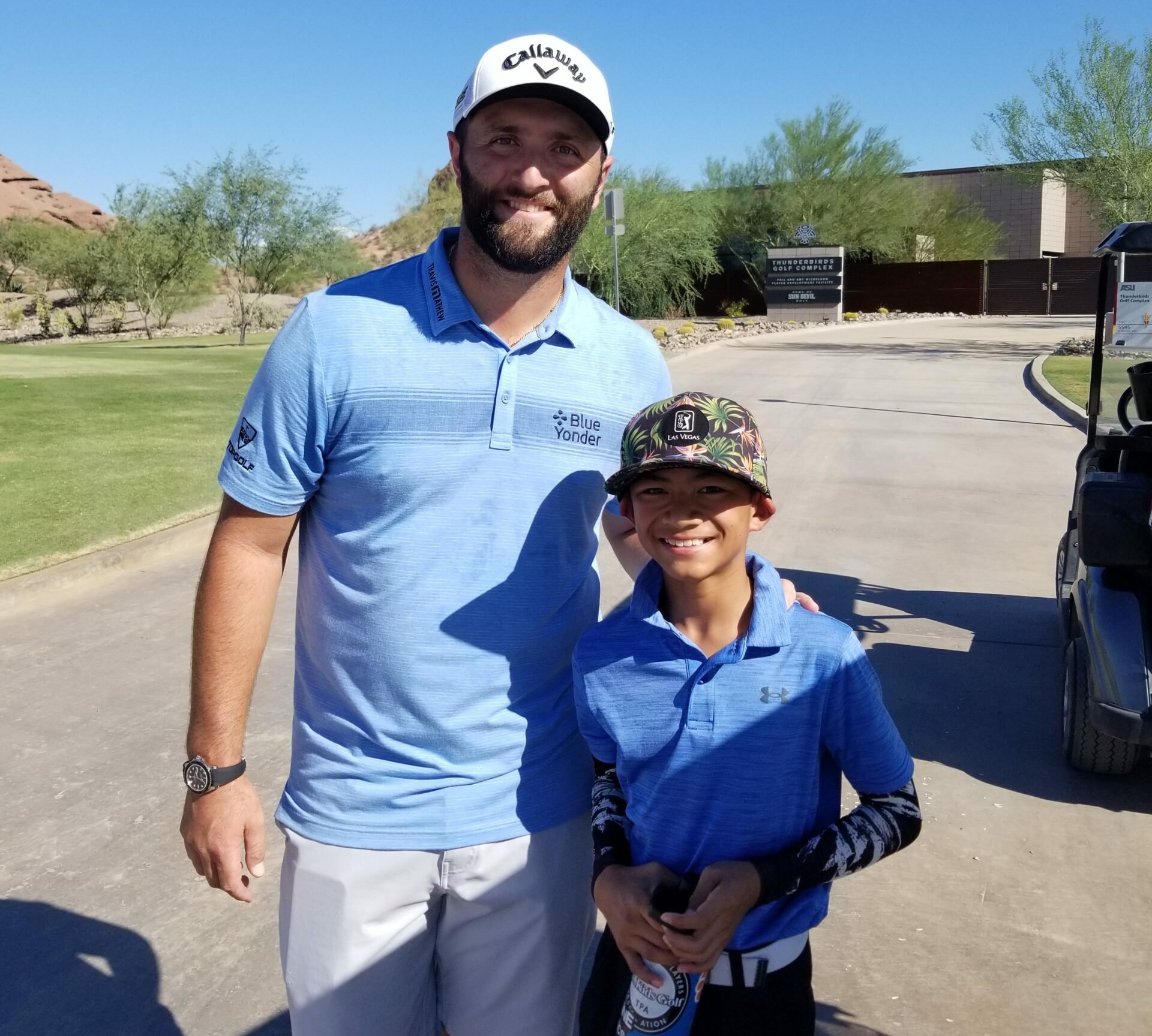 Youth on Course member Jaden Nacional with John Rahm at Papago Golf Course in Phoenix, AZ