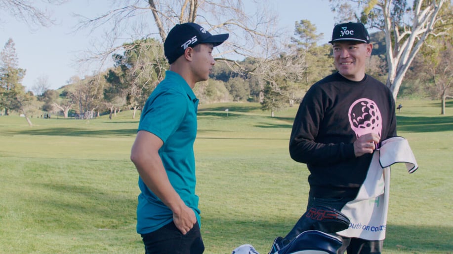 Youth on Course member talking to Youth on Course Vice President of Programs Michael Lowe while on the golf course