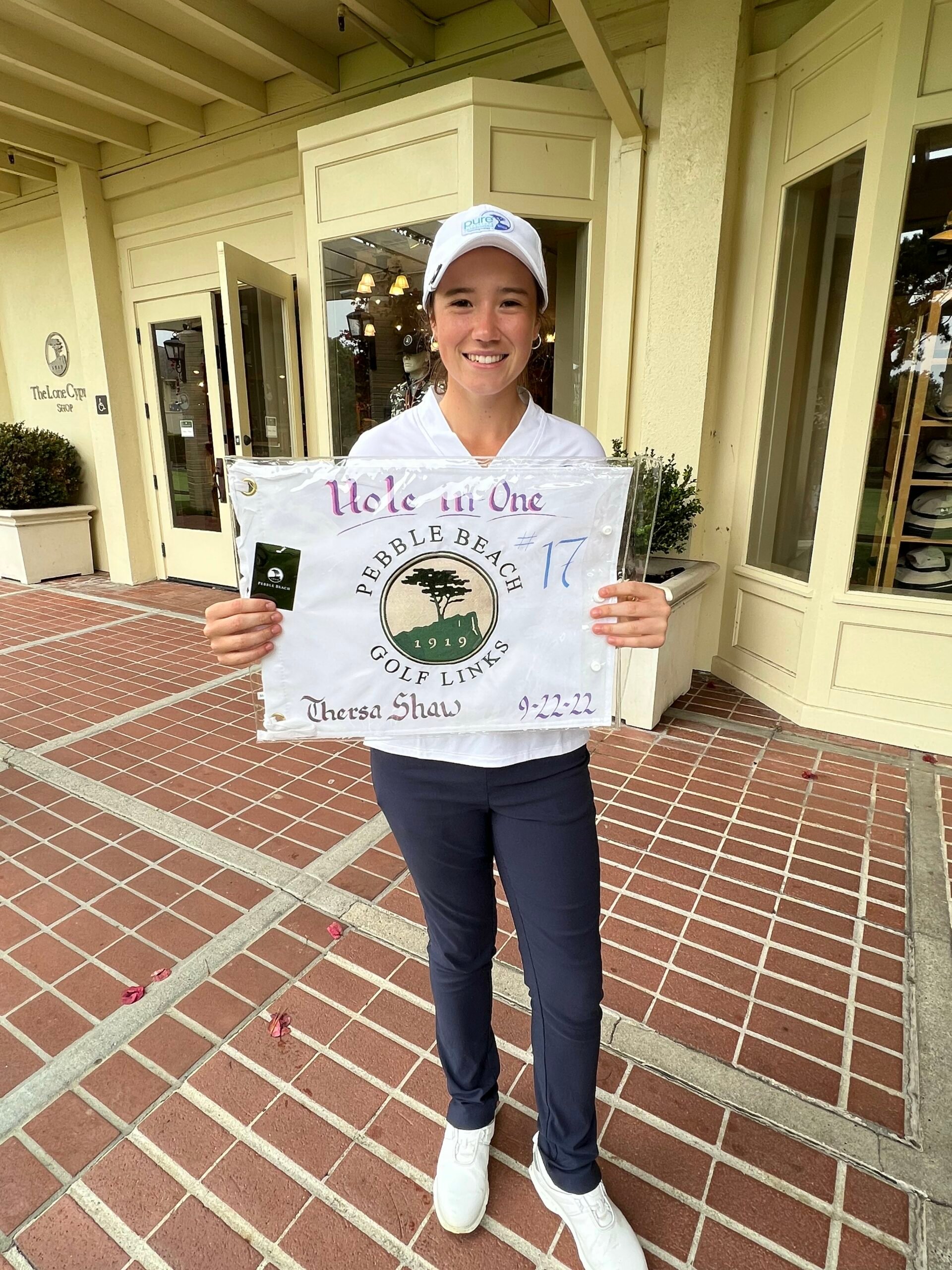 Youth on Course member Theresa Shaw with a hole-in-one Pebble Beach Golf Links flag