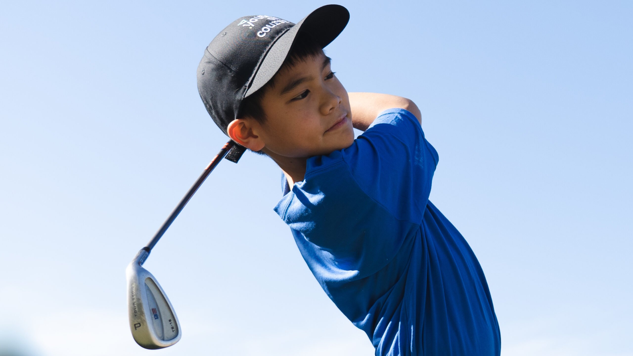 Youth on Course member taking a swing on the golf course