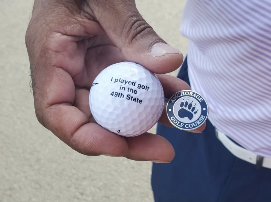 Golf ball Roberto and Teresa Correa received stating "I played golf in the 49th State" after playing golf at Anchorage Golf Course in Alaska
