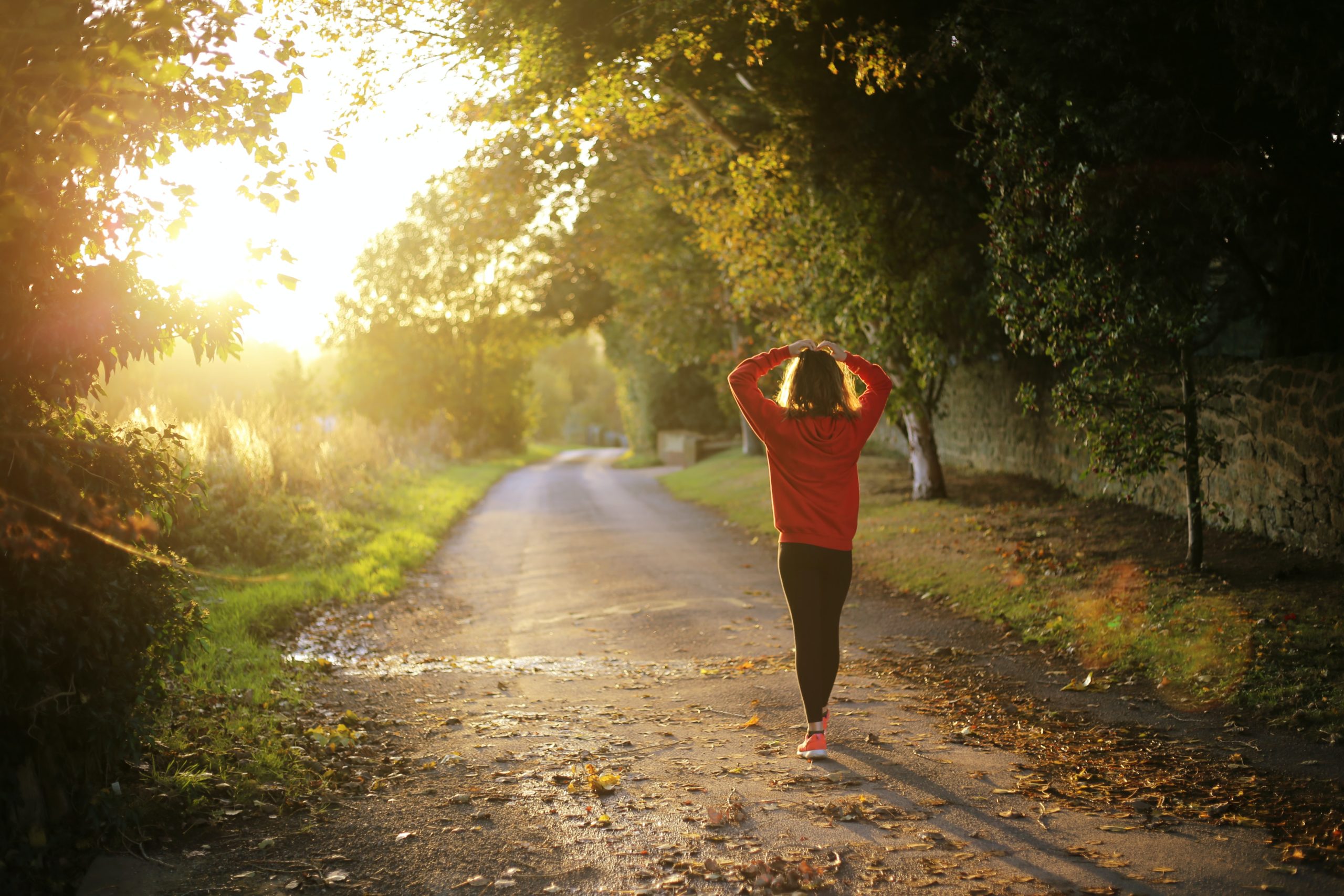 Girl walking on a sunlit path