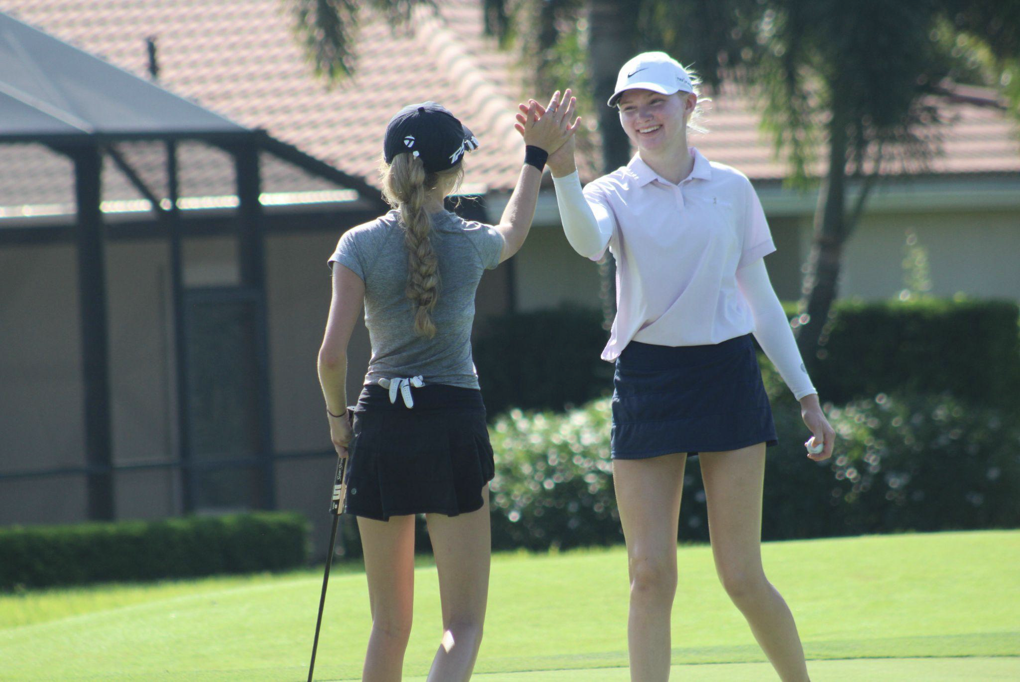 Female golfers from Florida enjoying the golf course and high fiving